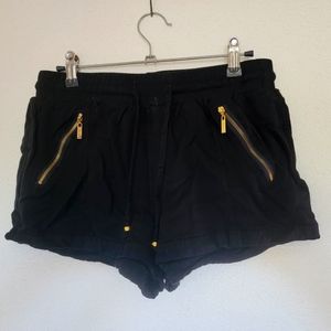Black shorts with gold zipper pockets